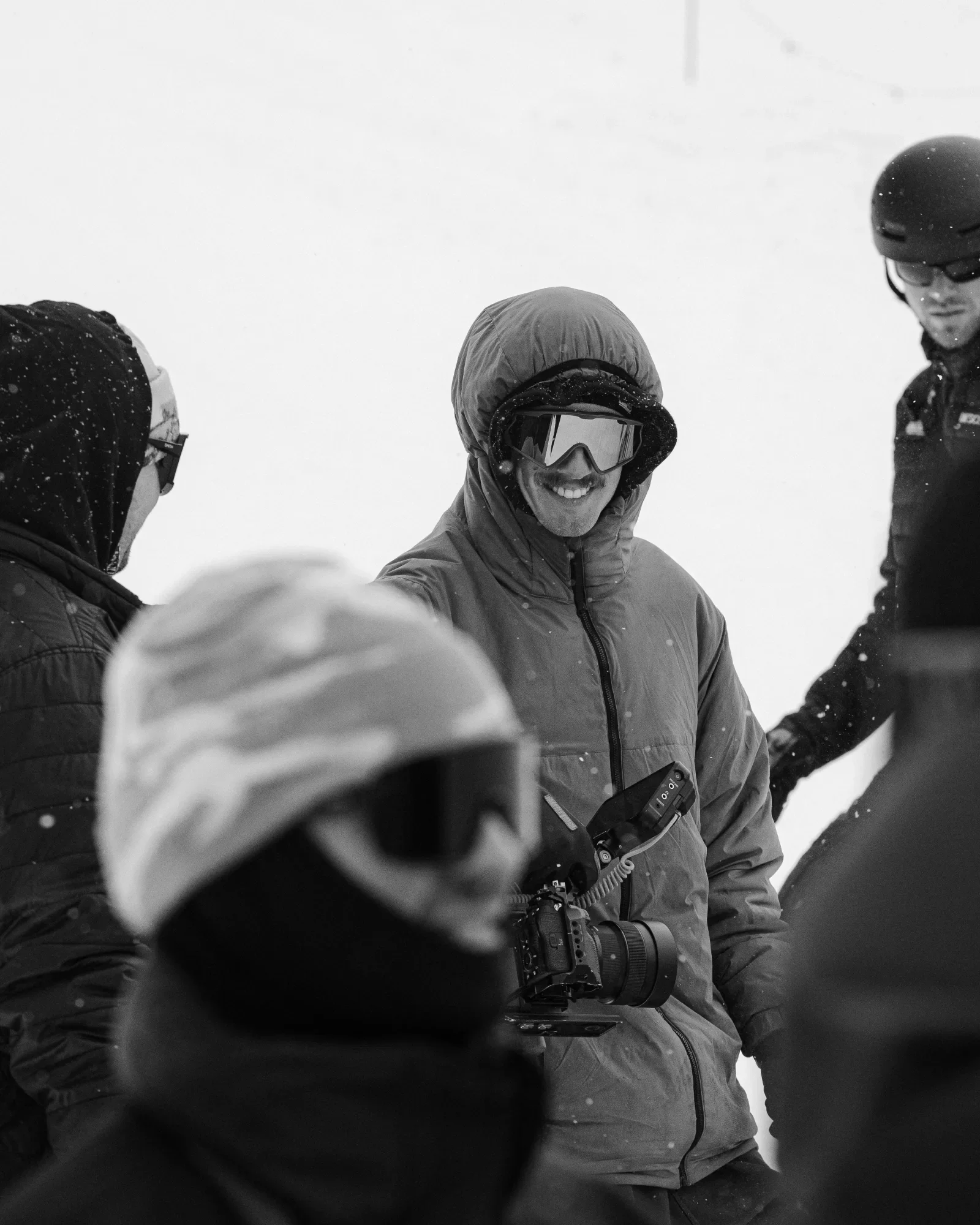 Carter working with a camera in falling snow