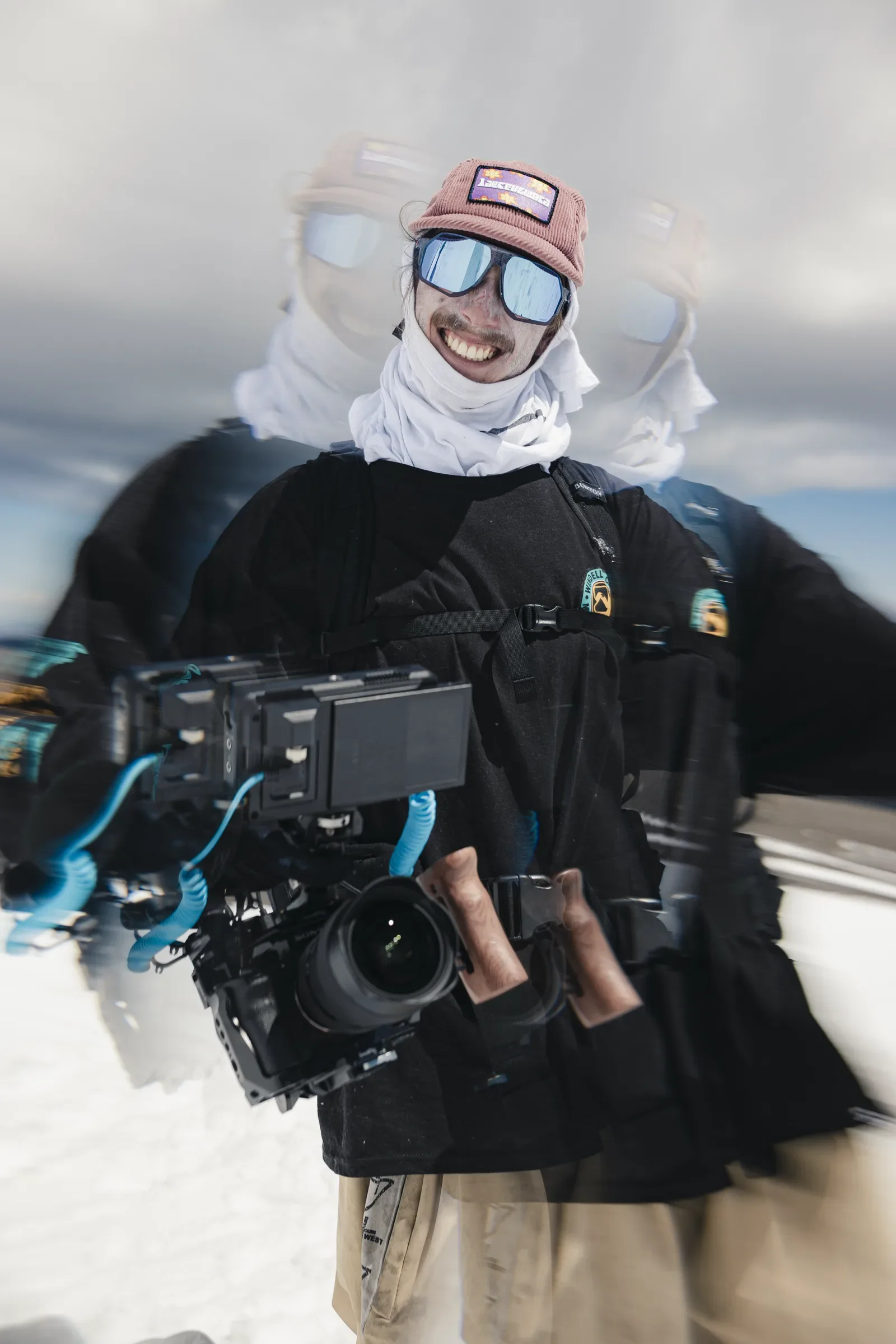 Carter holding a cinema camera during a winter production