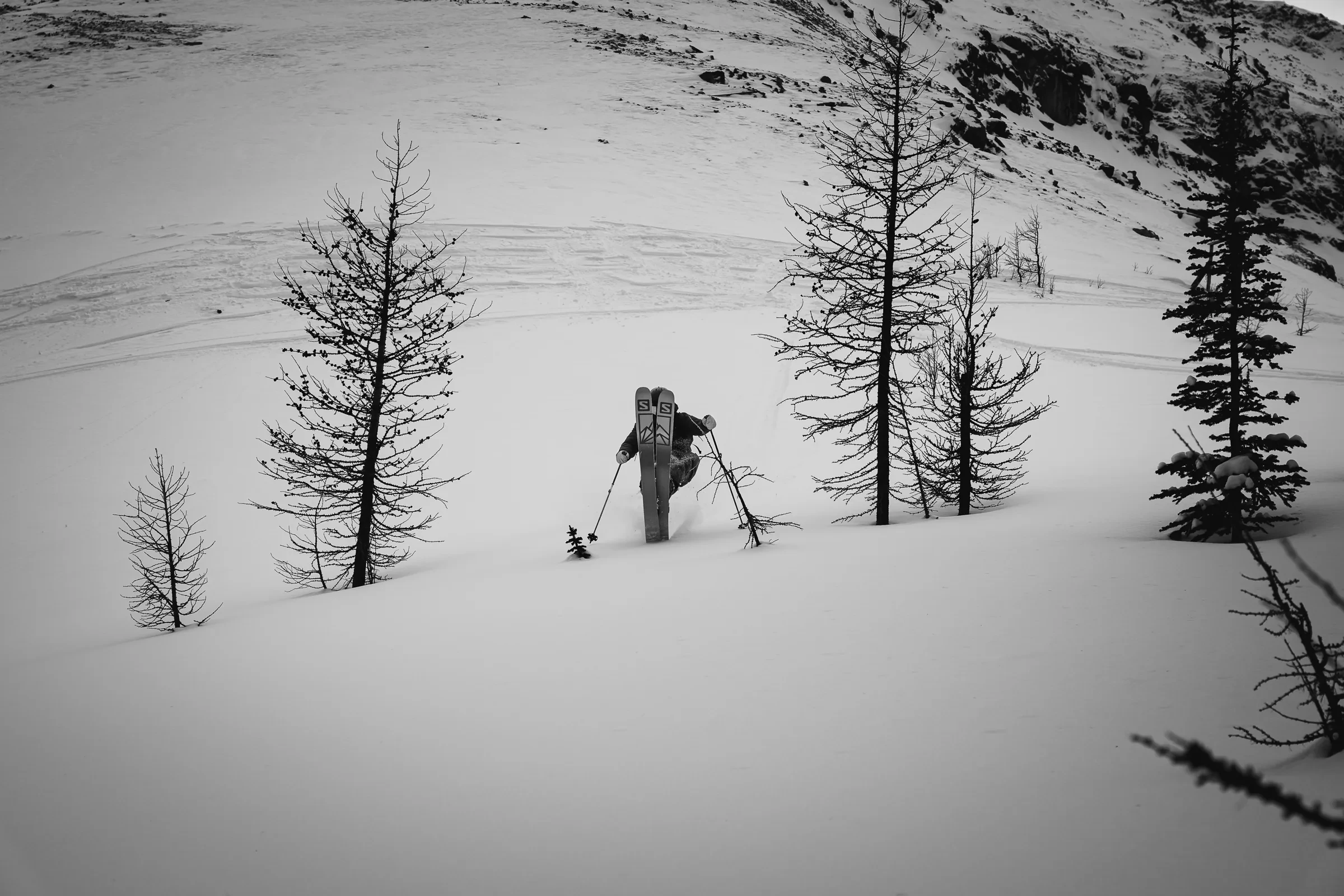 A skier and photographer framed against winter terrain