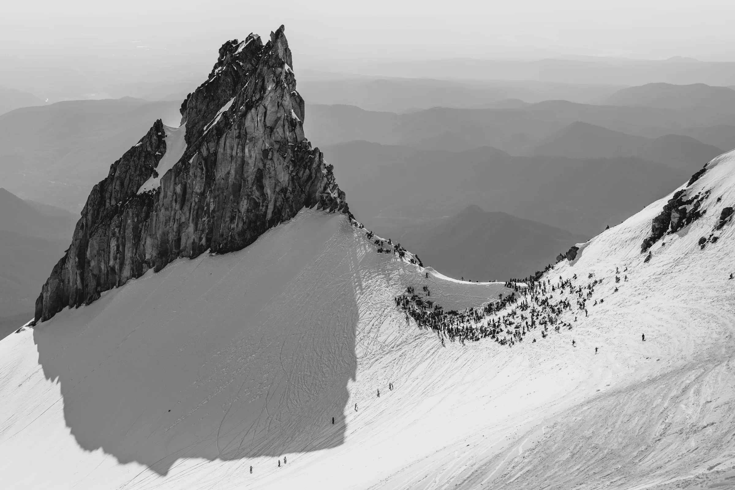 A skier and equipment set against broken mountain terrain