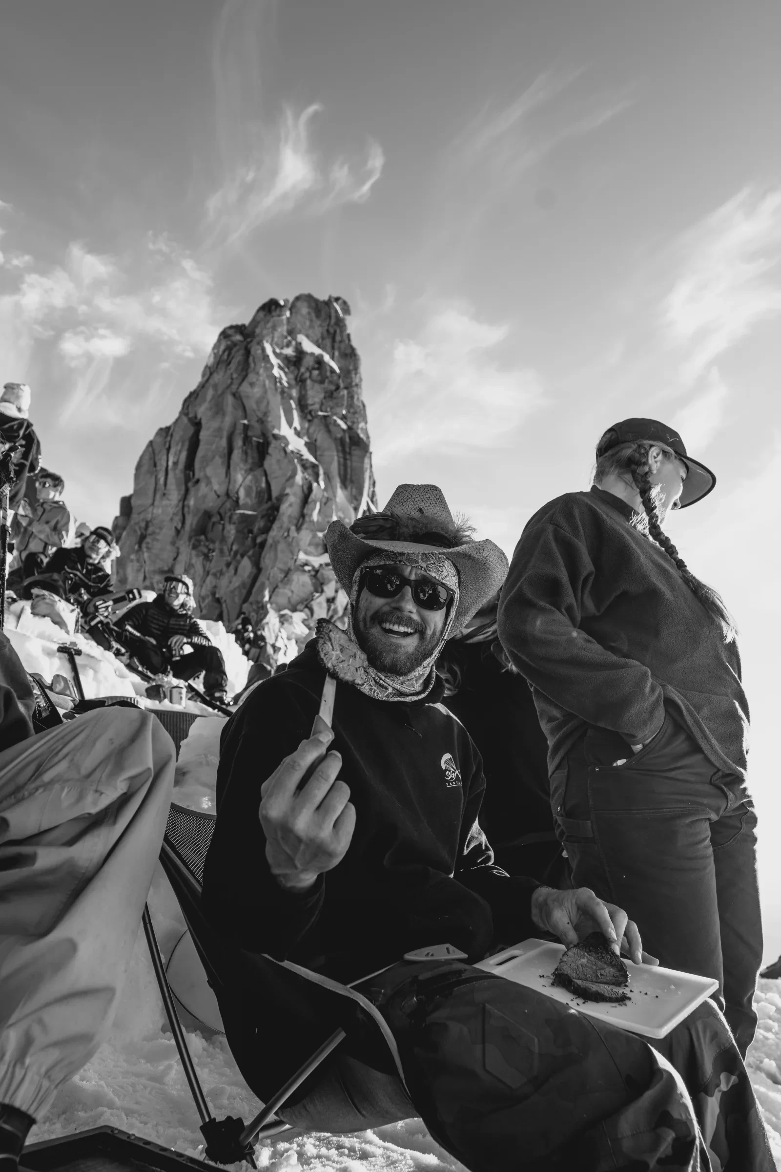 Friends gathered beneath an alpine spire
