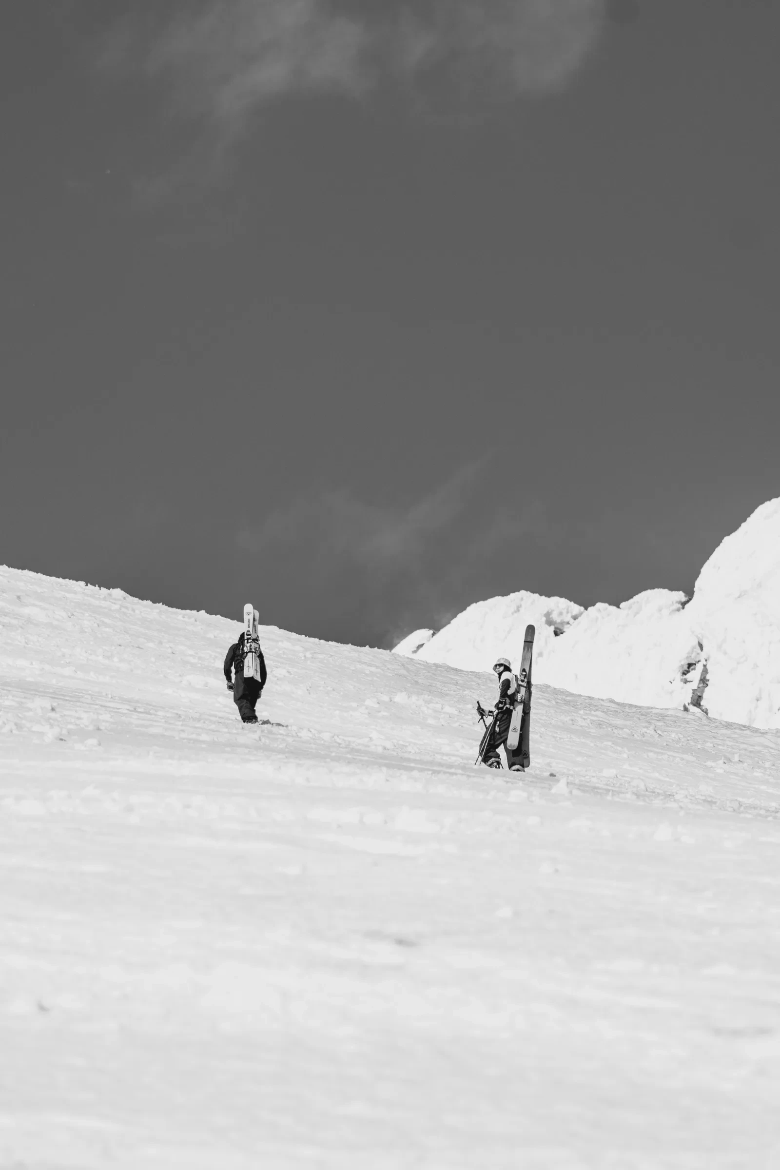 Friends pausing together beneath the summit
