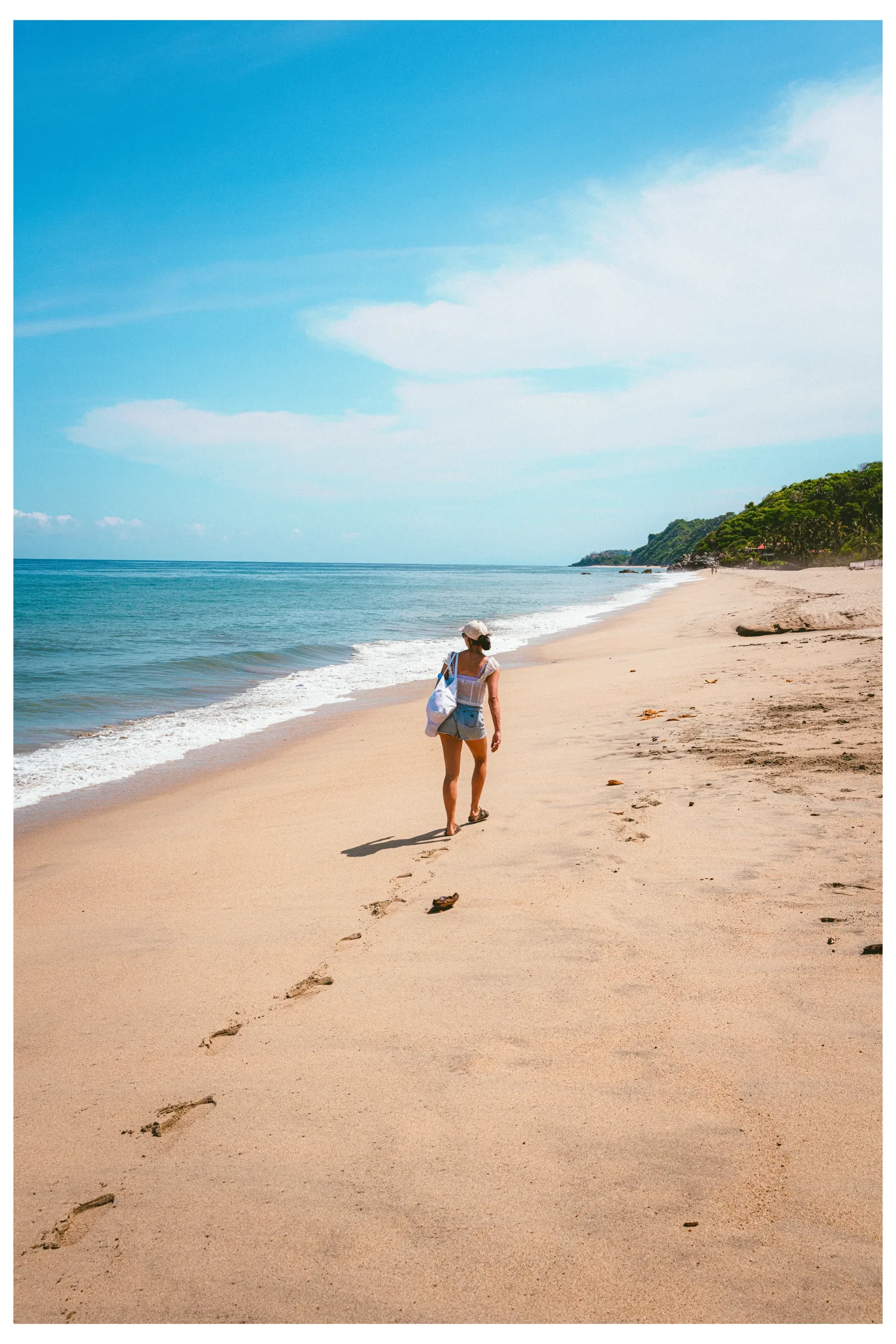Two people walking along an open beach