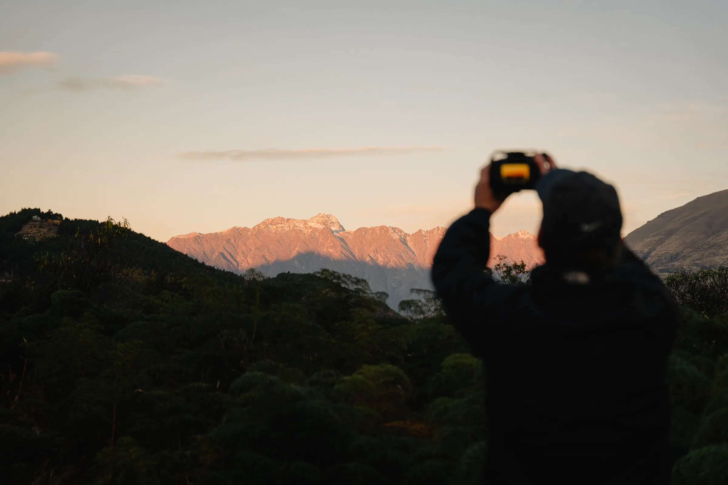 A traveller photographing the landscape at sunset