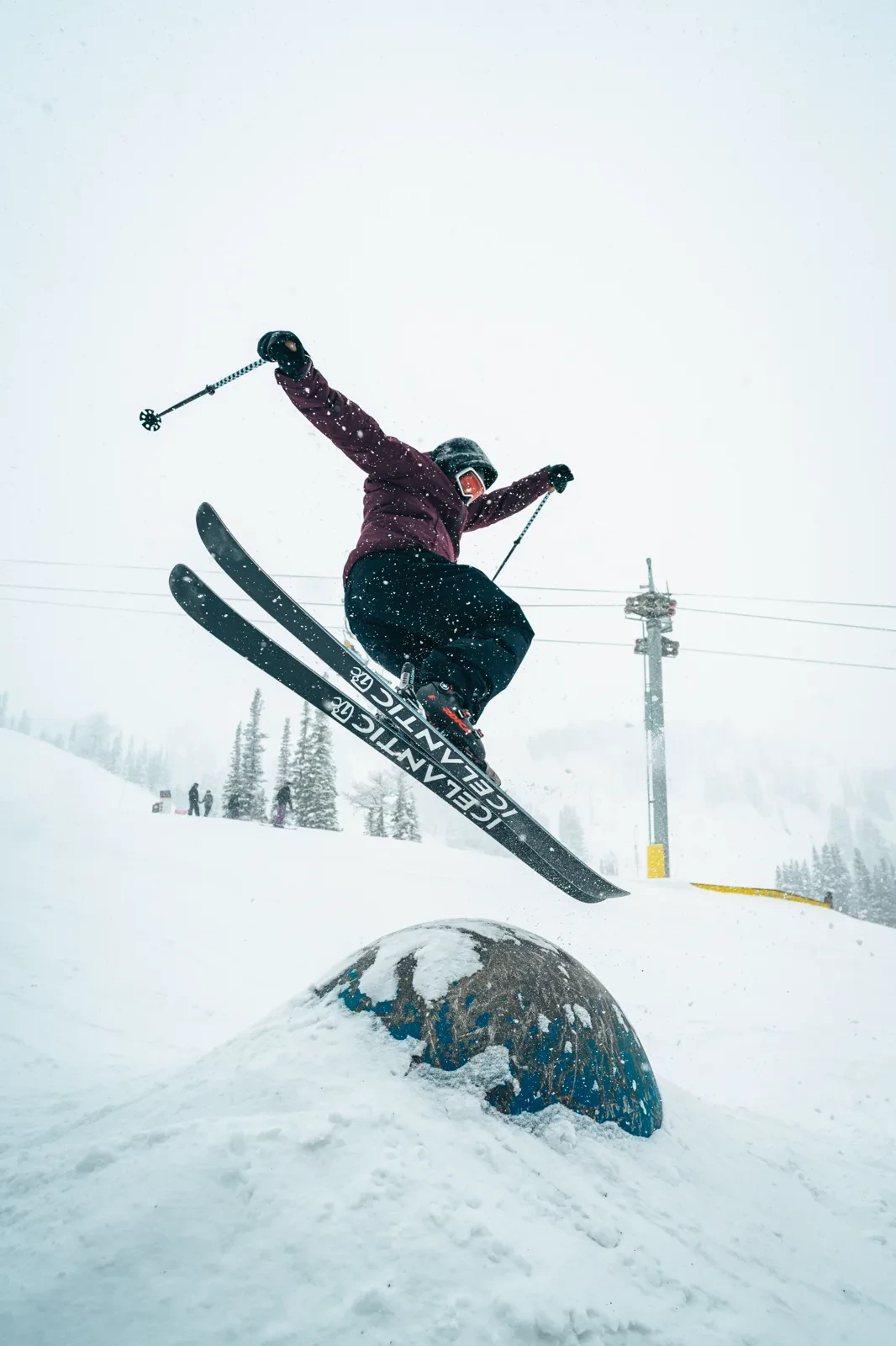 A skier airborne above a snowy feature
