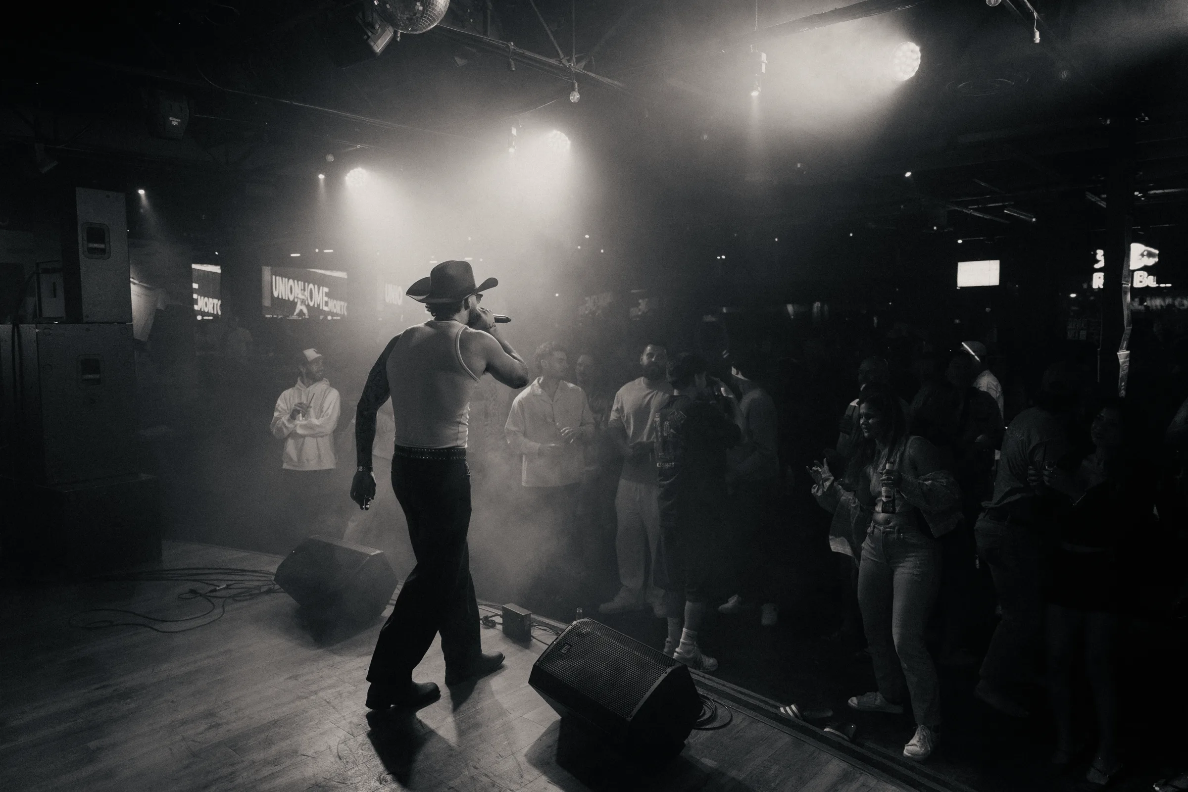 A performer moving across a smoky stage