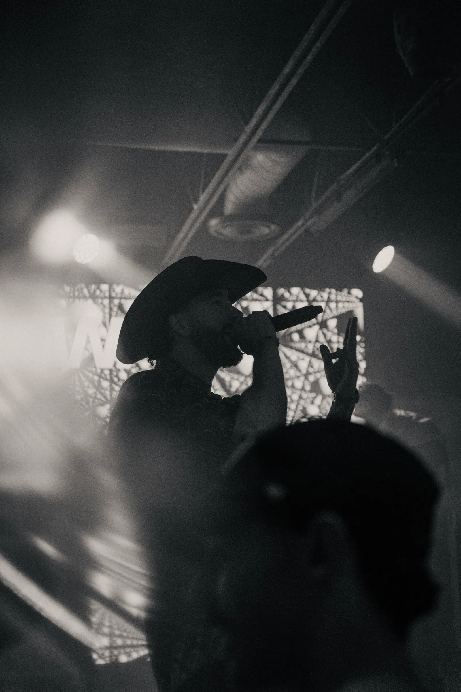 A camera operator filming the performance in black and white