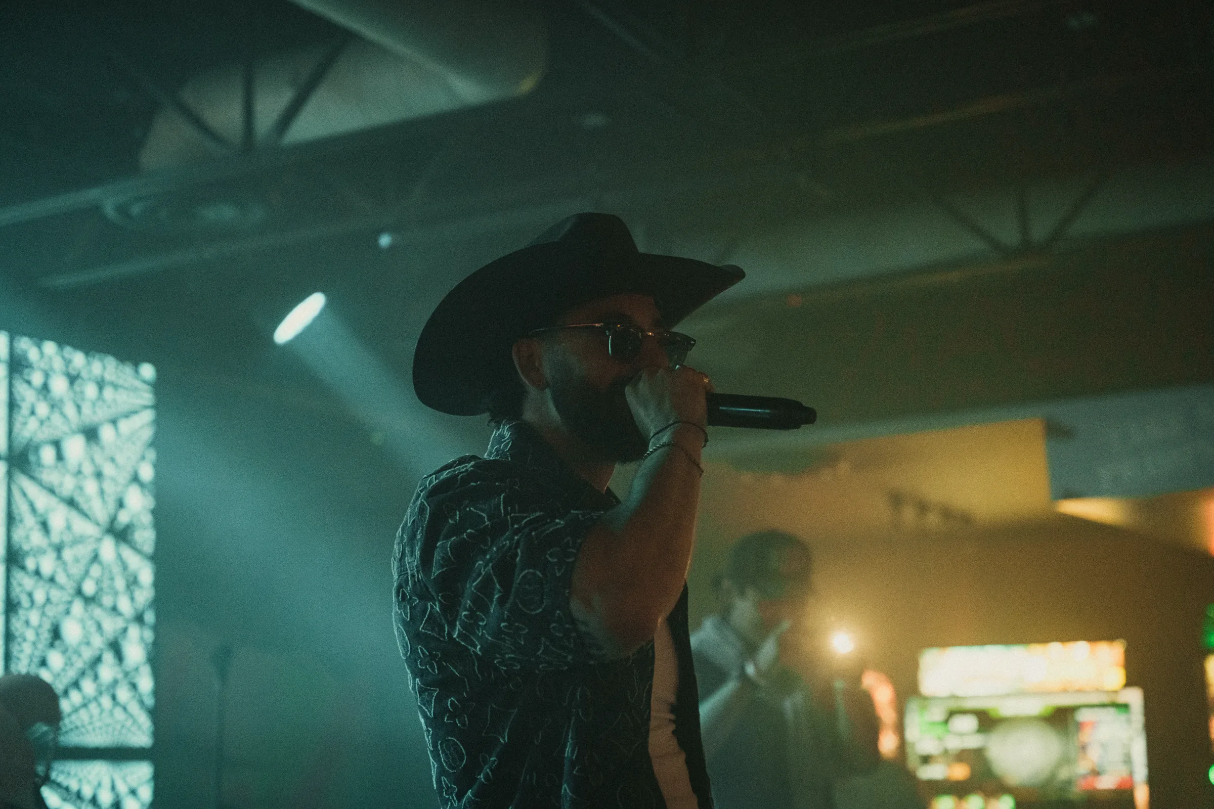 A performer and audience inside the dark venue