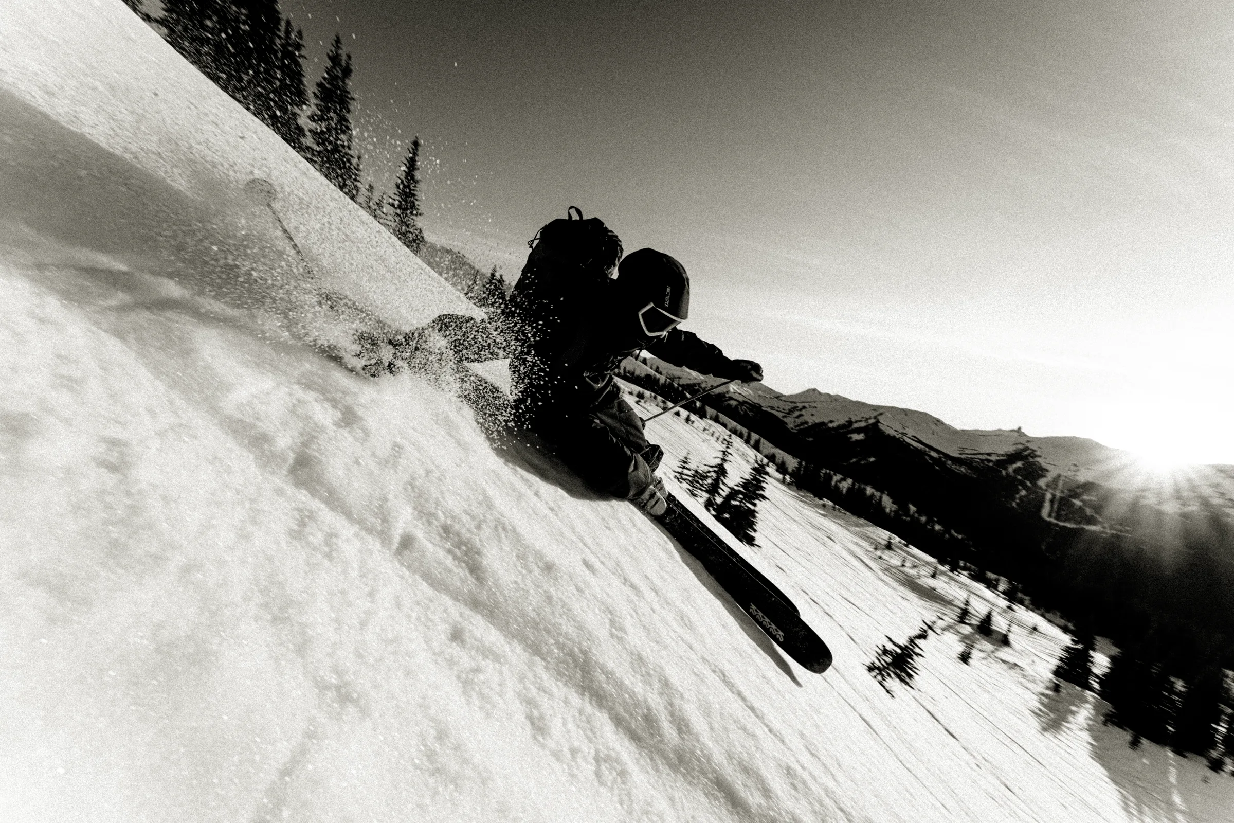 A skier driving through a steep turn