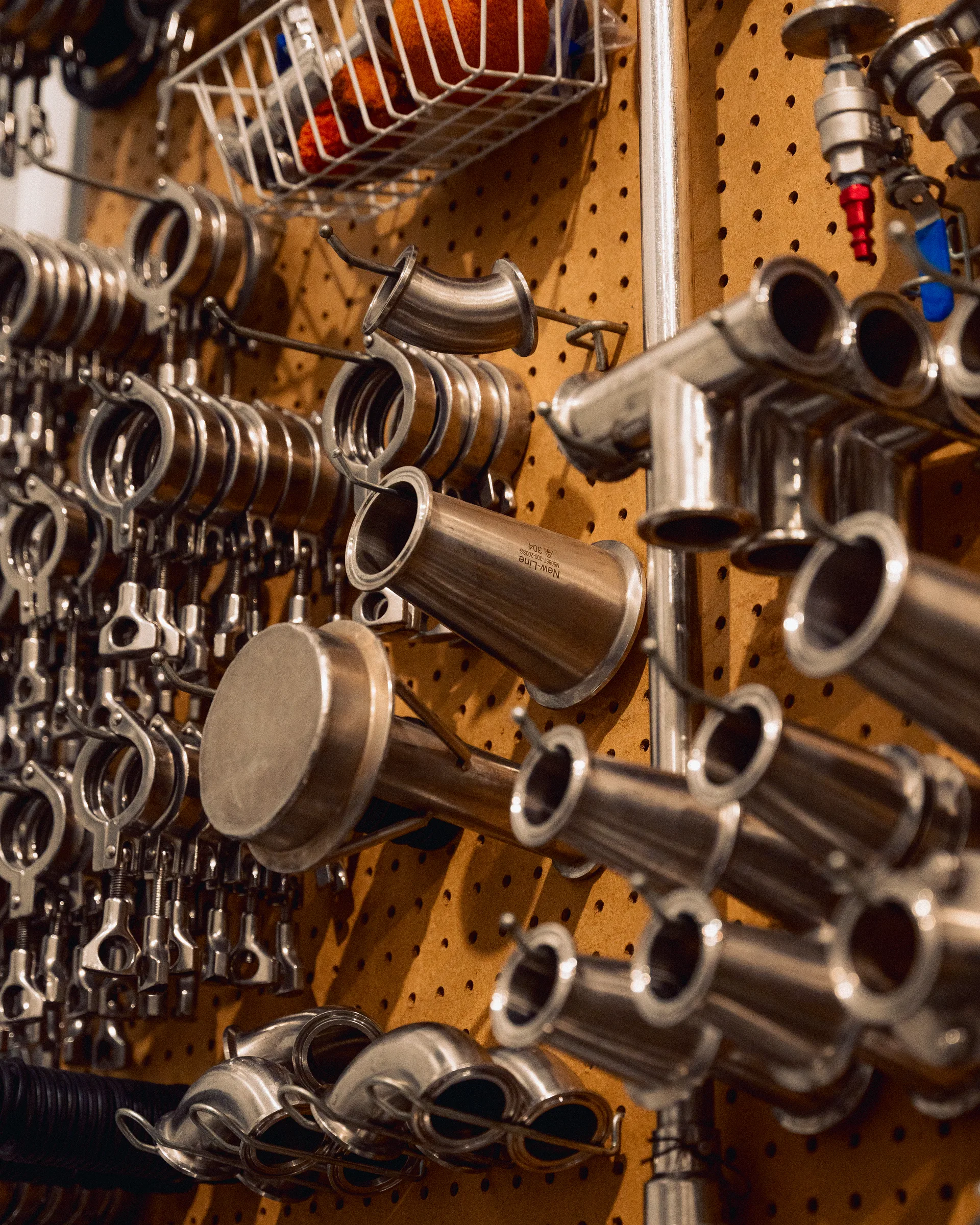 Winery fittings arranged on a workshop wall