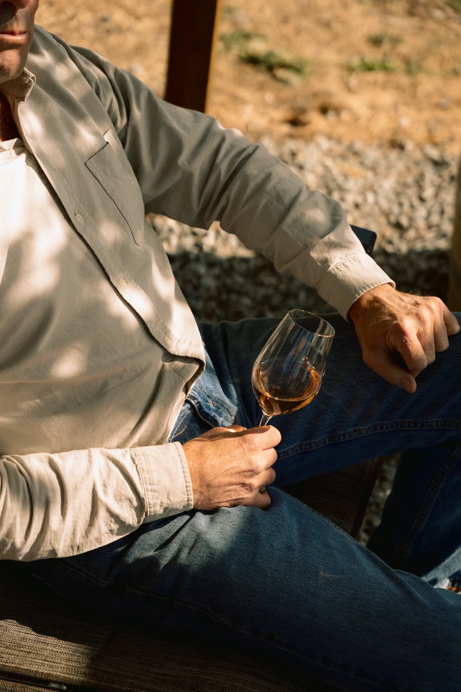 A seated person holding a glass of rosé