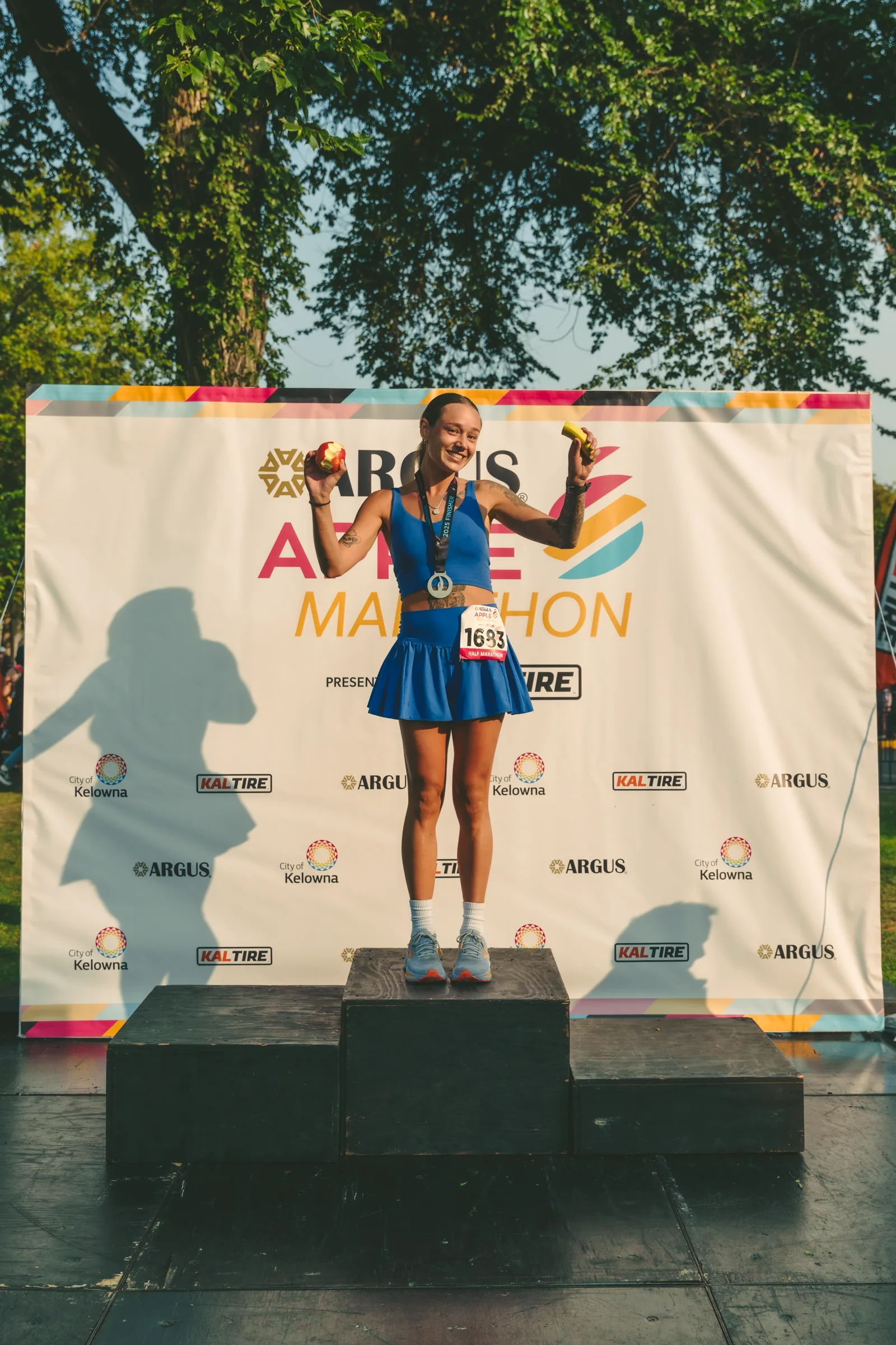 A runner on the podium in front of the event backdrop