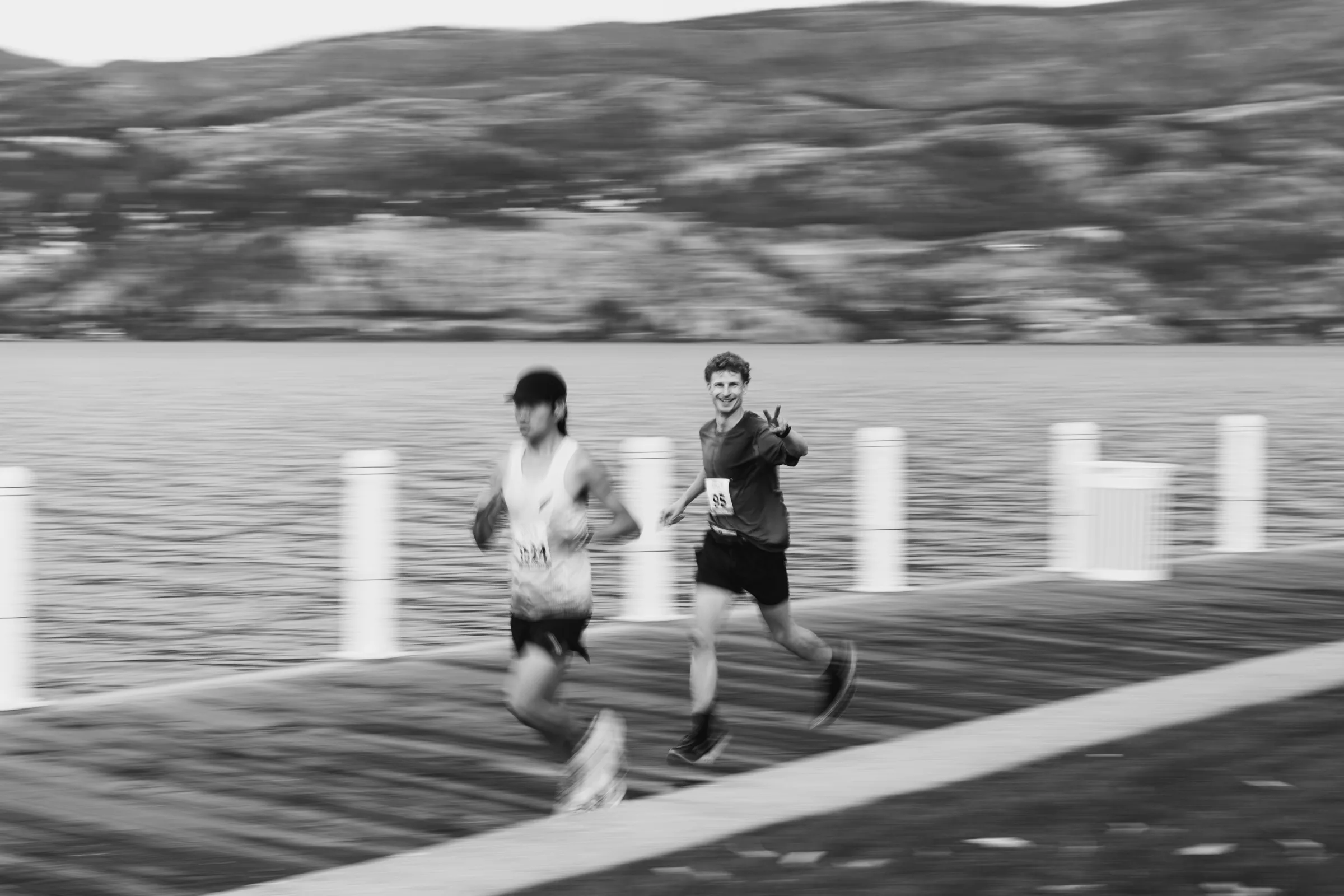 A runner moving through a blurred black-and-white crowd