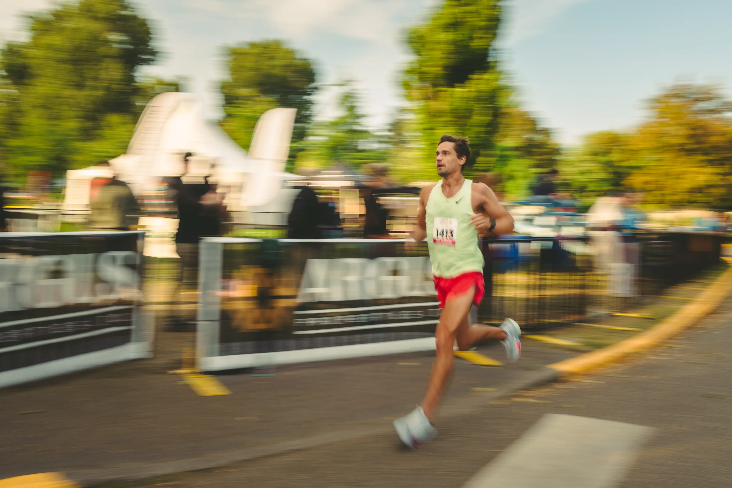 A runner passing the finish area with motion blur