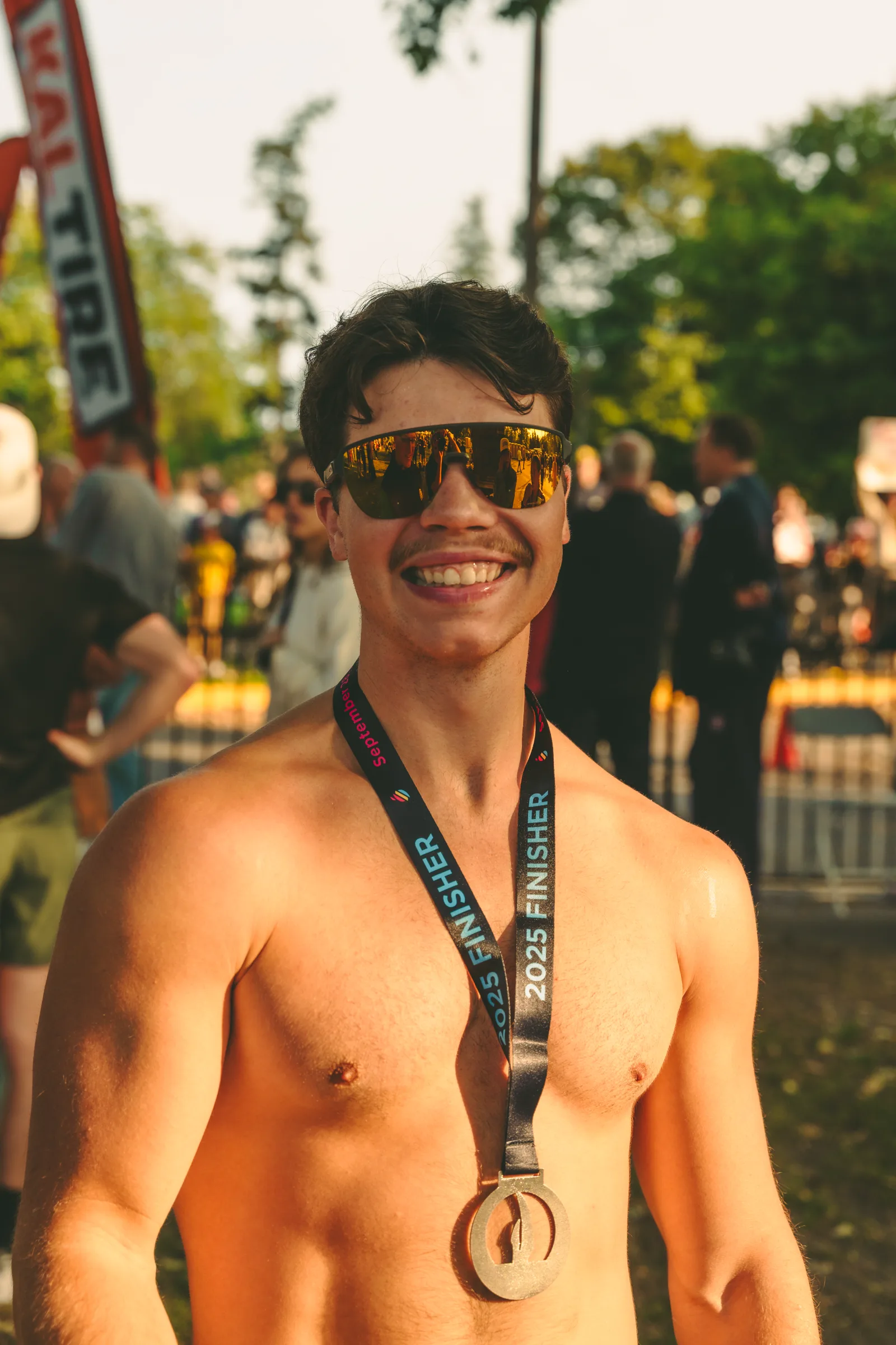 A participant wearing a Kelowna Apple Marathon medal