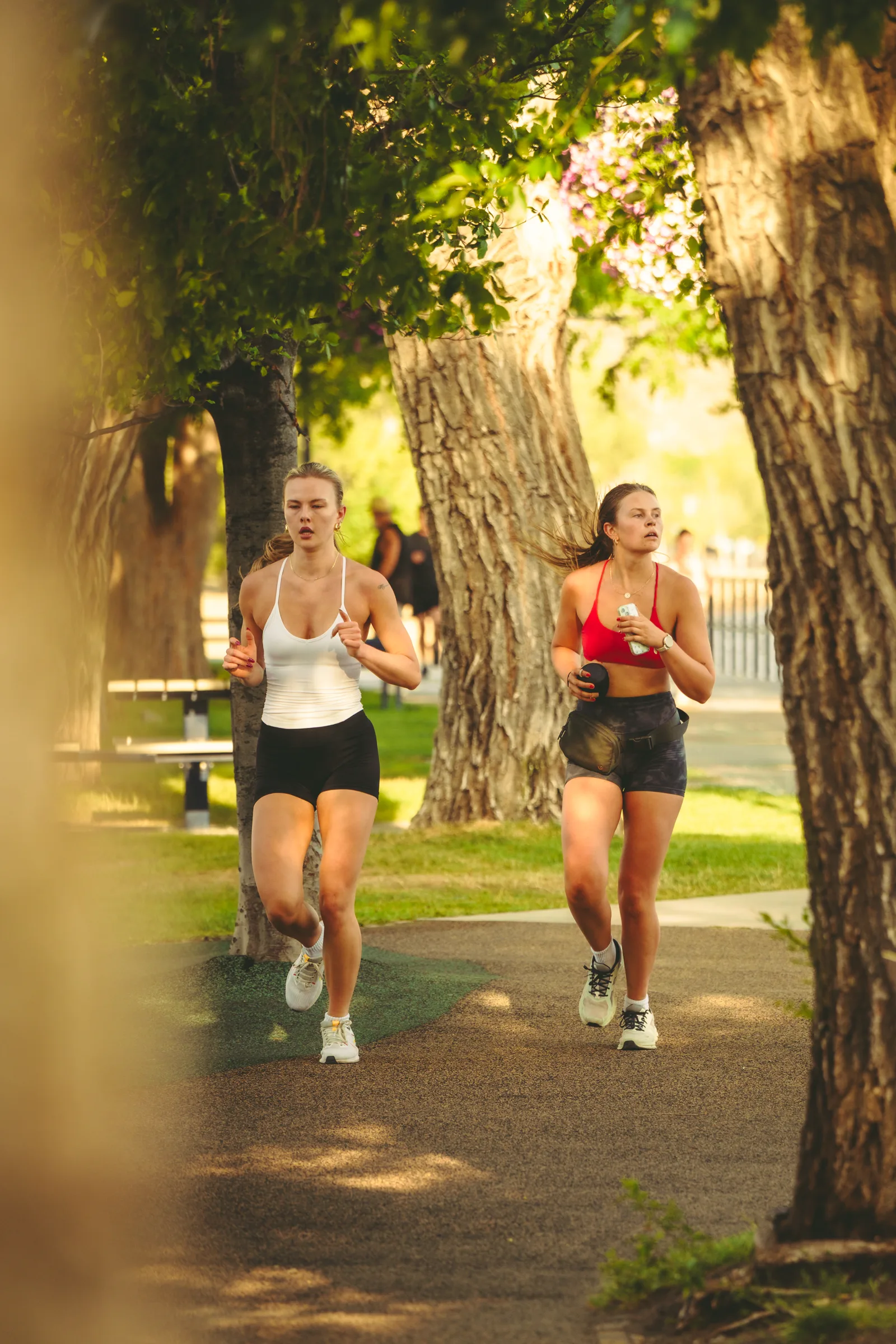Two runners moving through warm morning light