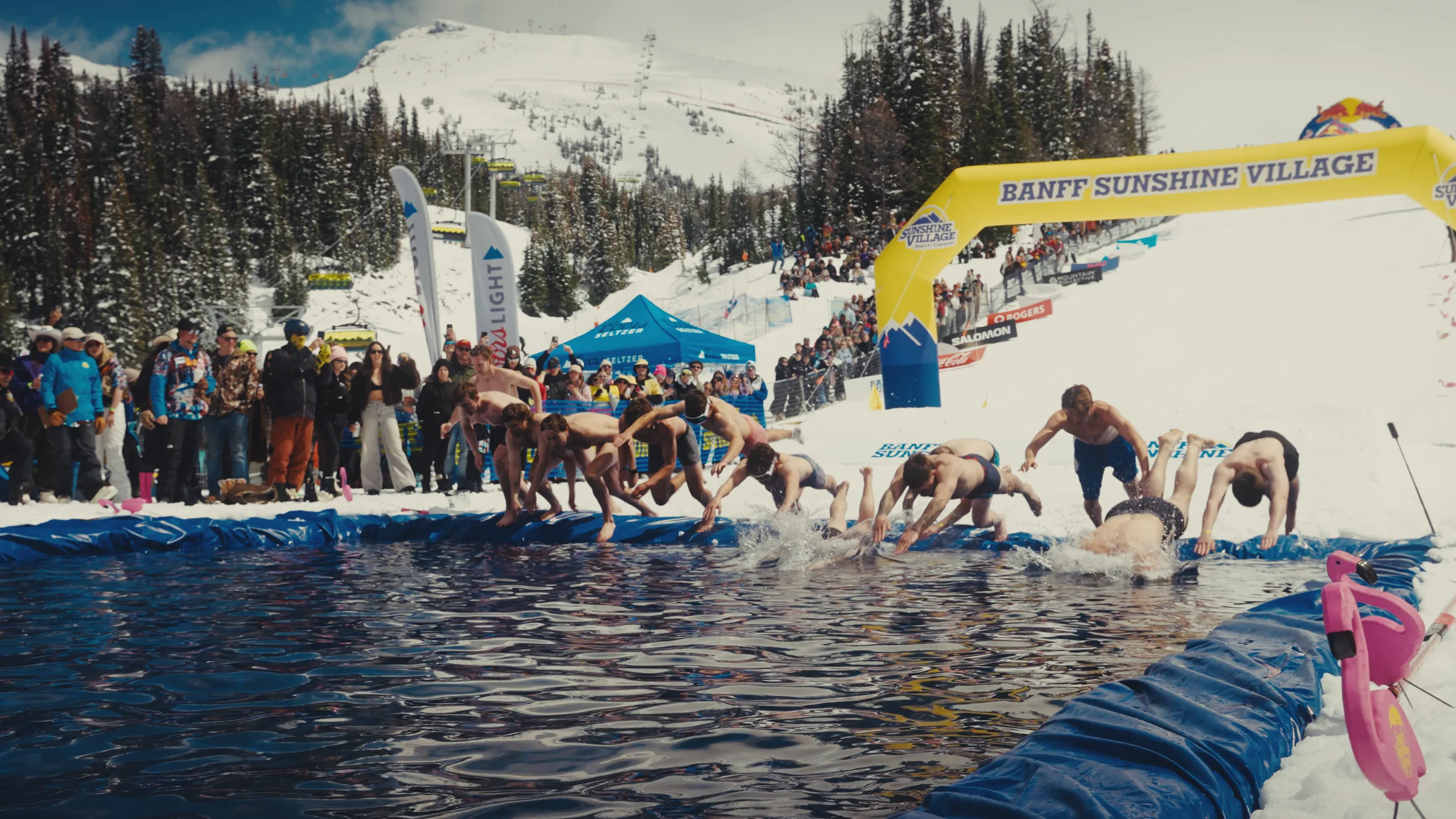 Competitors entering the Slush Cup pond together