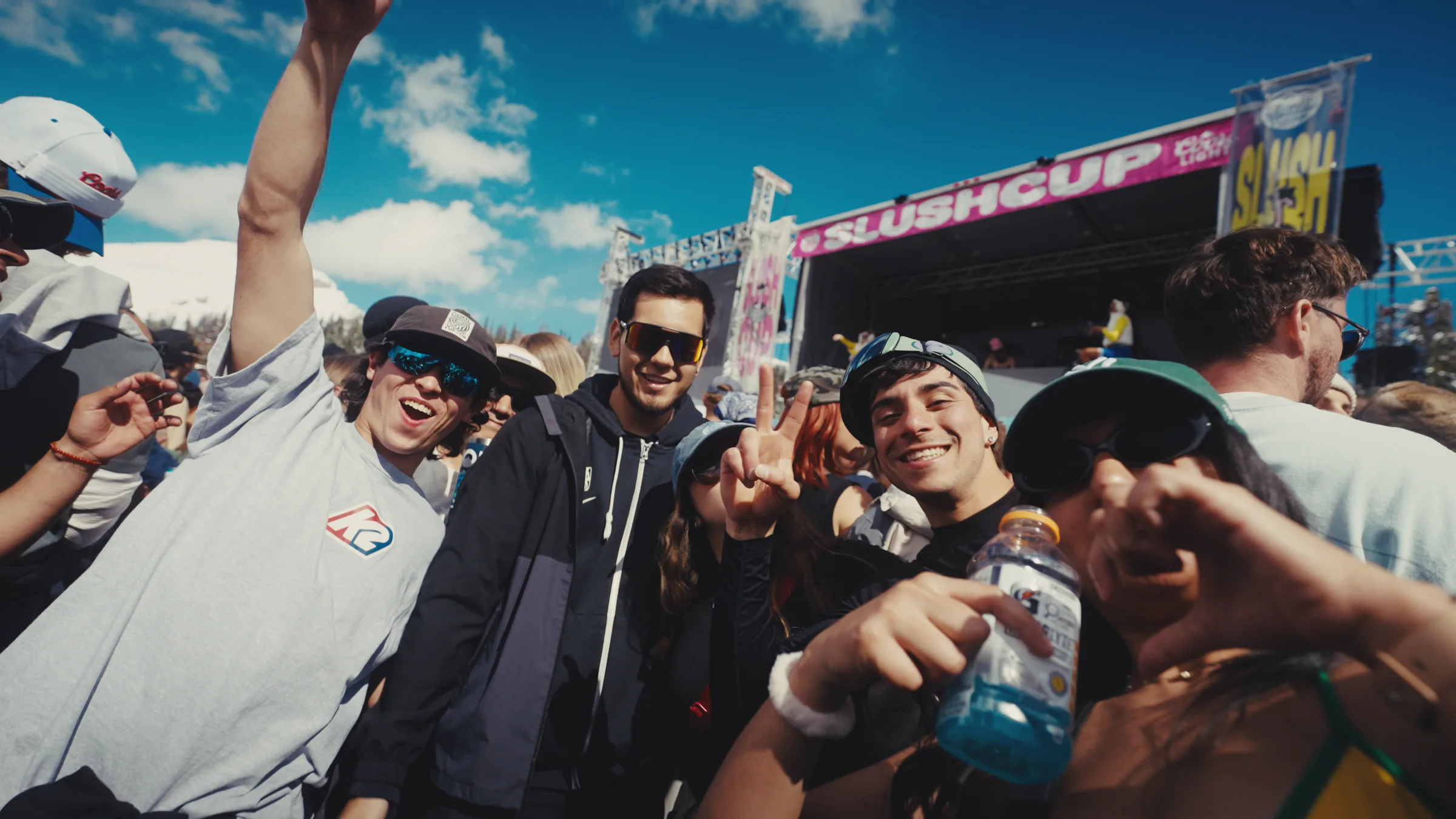 A group posing in front of the Slush Cup stage