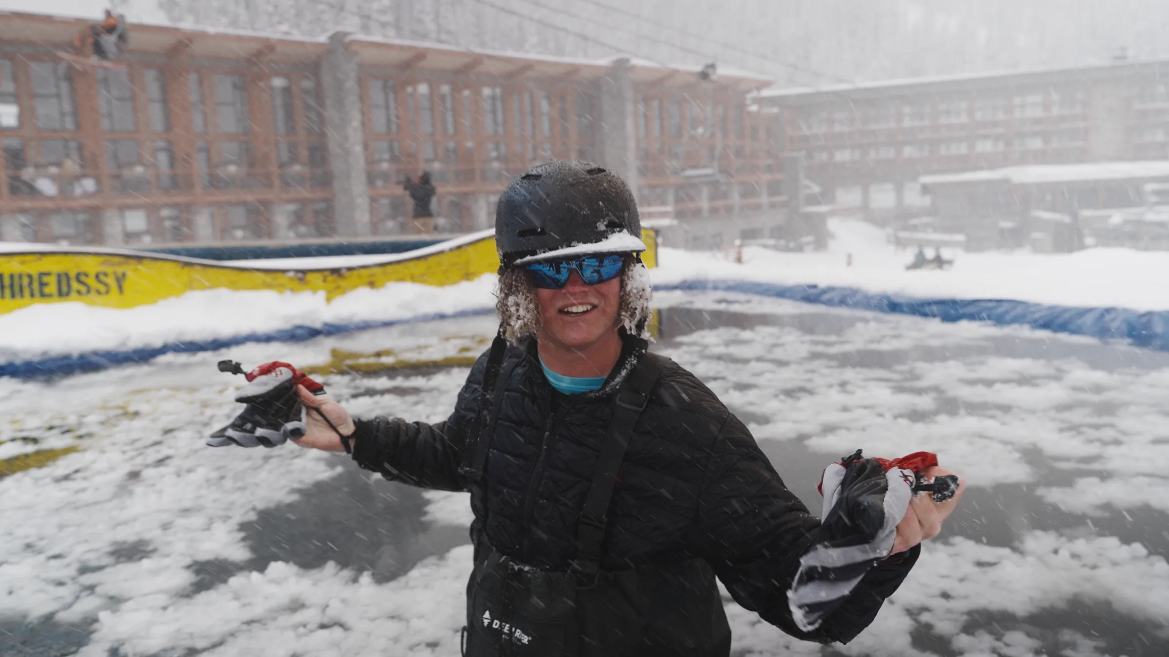 A snow-covered Slush Cup participant beside the pond
