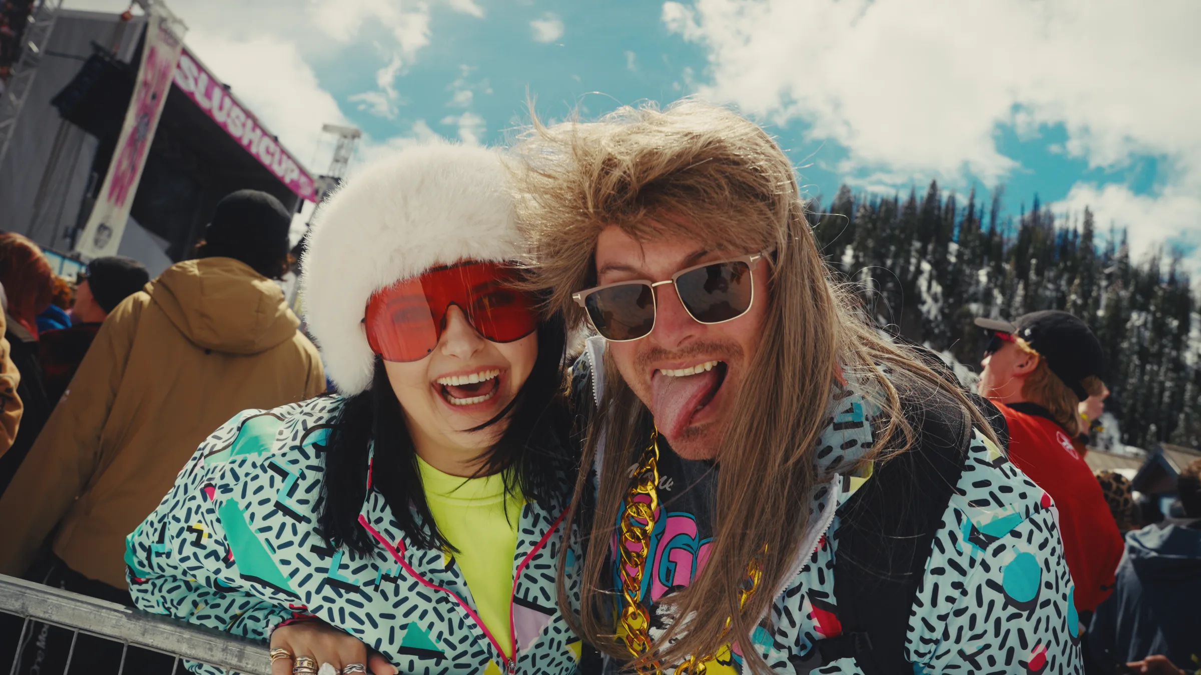 Two costumed Slush Cup spectators smiling at the camera