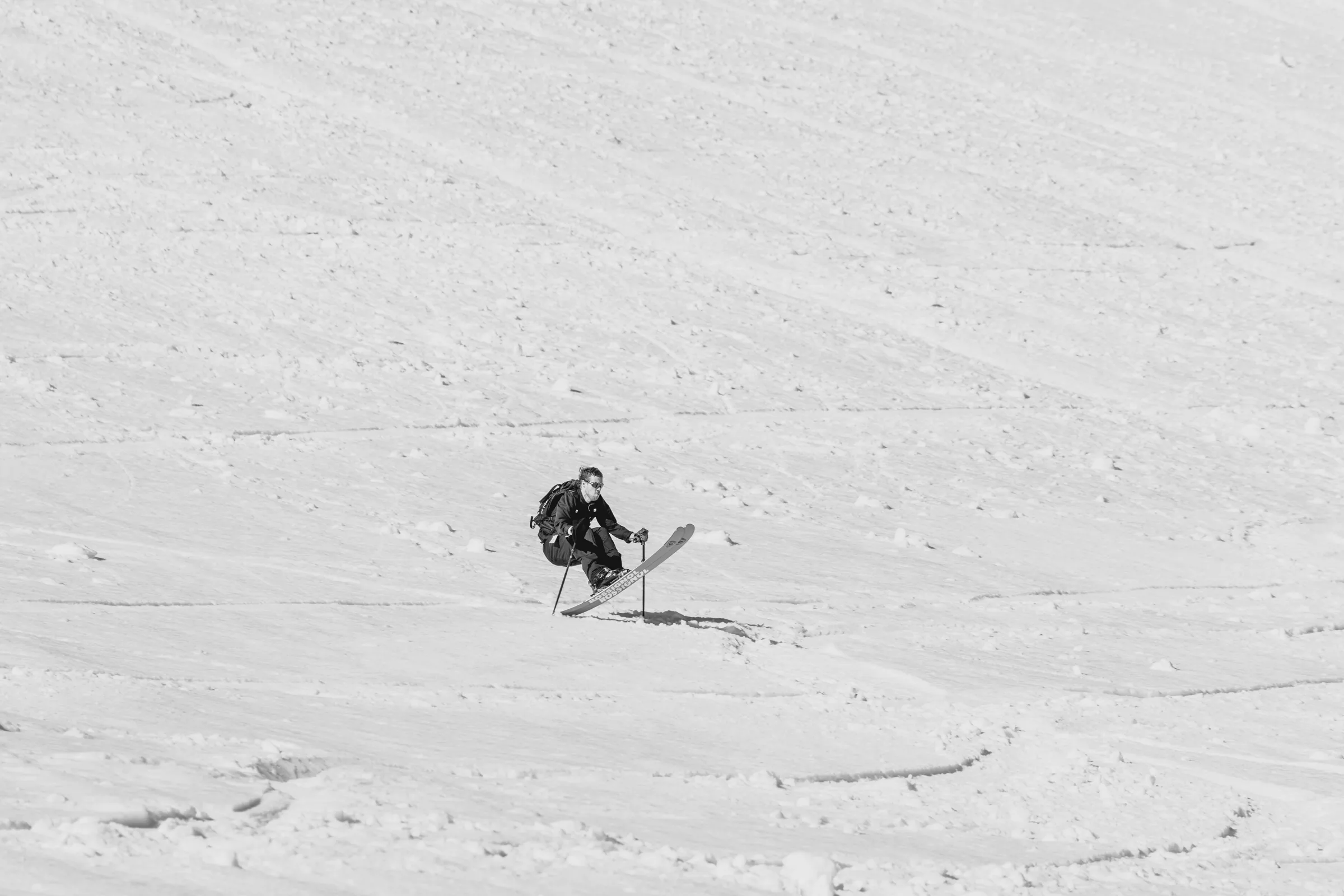 A skier descending an open snow face