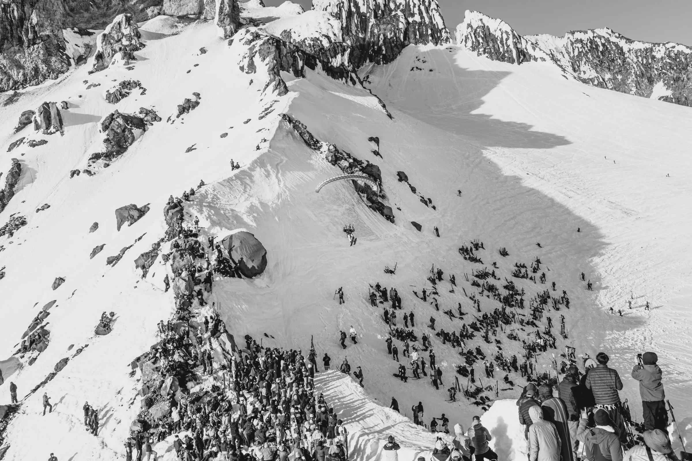 A steep snow face beneath a broken ridge