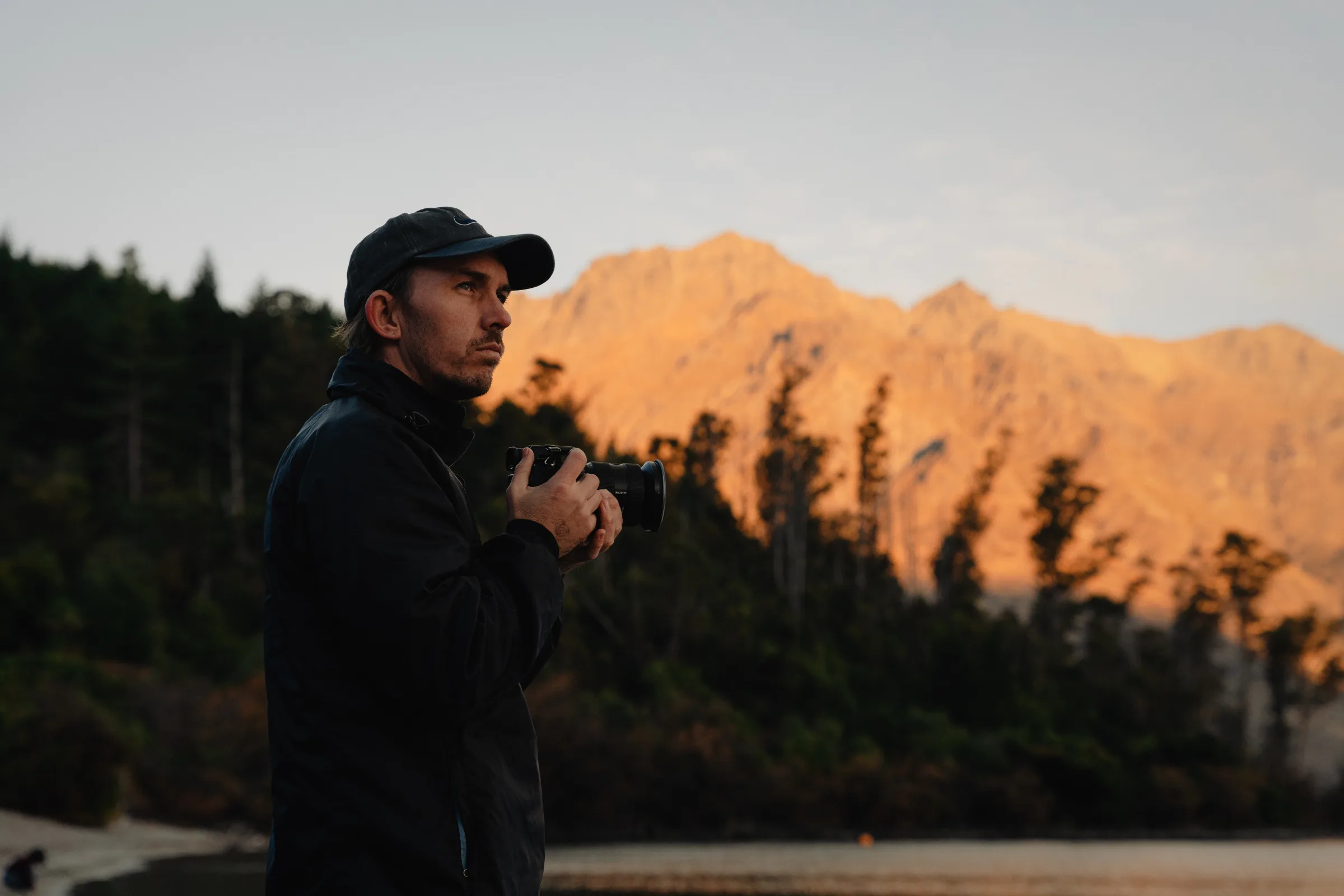 A traveller framed against sunlit mountains