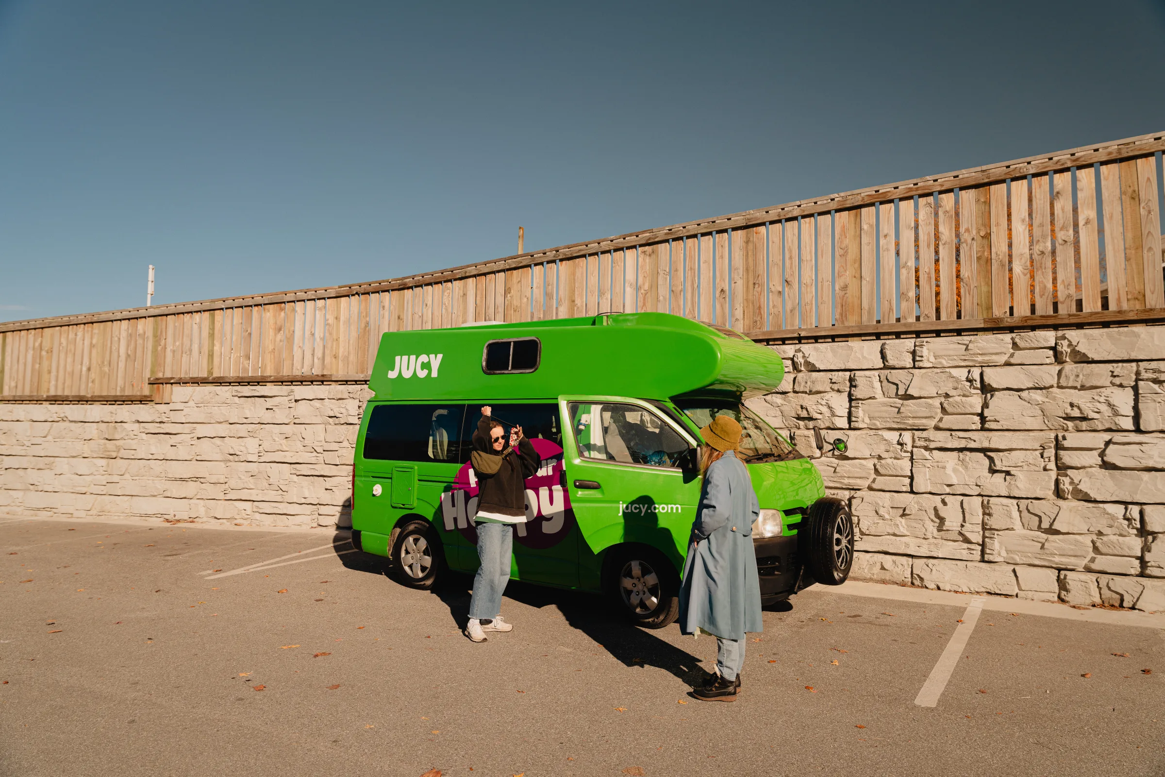 A bright green camper van at a roadside stop